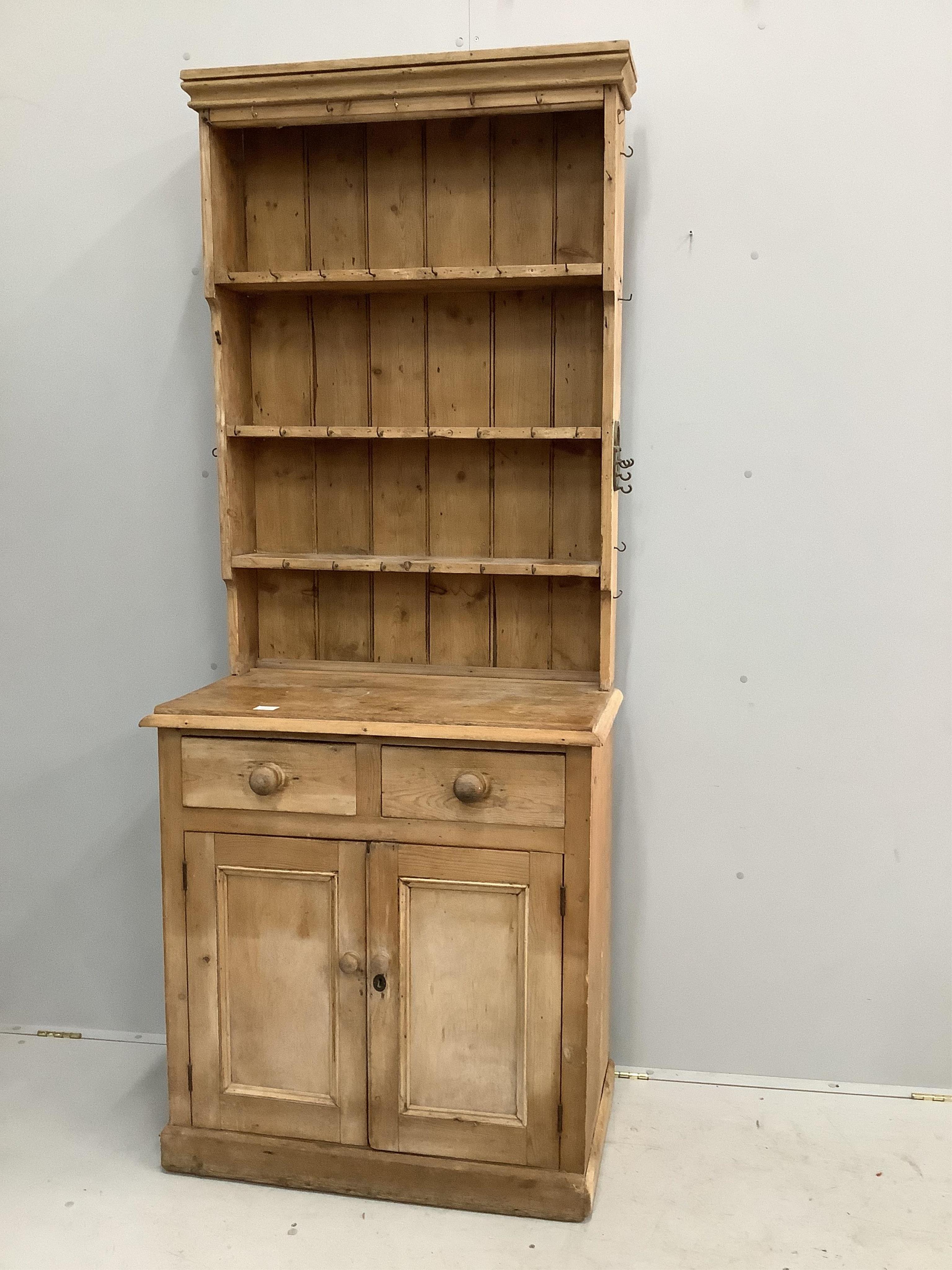 A narrow Victorian style pine dresser with boarded rack, width 85cm, depth 48cm, height 210cm. Condition - fair